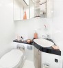 Interior der hellen Nasszelle in Wei mit Toilette, Sple und Spiegel